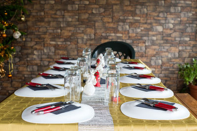 Close-up of objects on table against brick wall