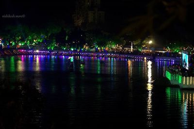 Reflection of illuminated lights in puddle