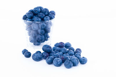 Close-up of blueberries against white background