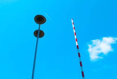 Low angle view of street light against blue sky