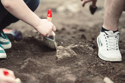 Low section of man tying shoelace