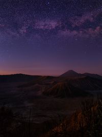 Scenic view of landscape against sky at night