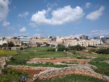 Buildings in town against sky