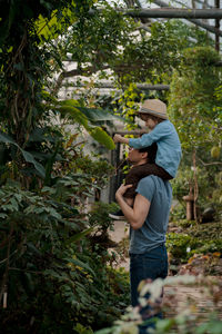 Adventurous family inspecting tropical gallery in botanical garden. local travel