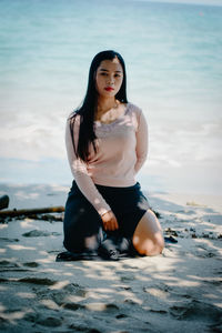 Young woman sitting in sea