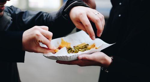 Midsection of people having food