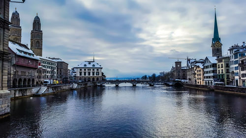 Bridge over river amidst buildings in city