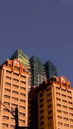 Low angle view of buildings against clear blue sky