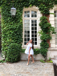 Woman standing outside building