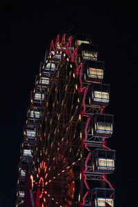 Low angle view of illuminated ferris wheel at night