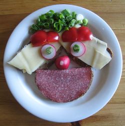 High angle view of anthropomorphic face made from meat and vegetables