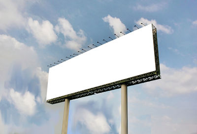 Low angle view of signboard against sky