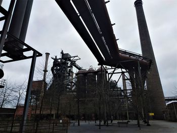 Low angle view of crane against sky