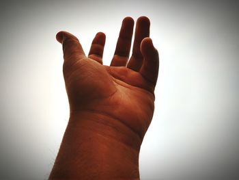 Close-up of human hand against the background