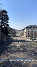 Road by city against clear sky