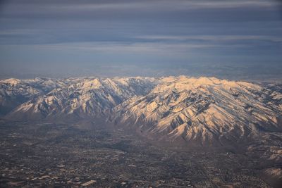 Wasatch front rocky mountain range aerial snow capped peaks winter urban salt lake city utah usa