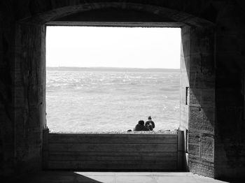 View of sea against sky seen through window