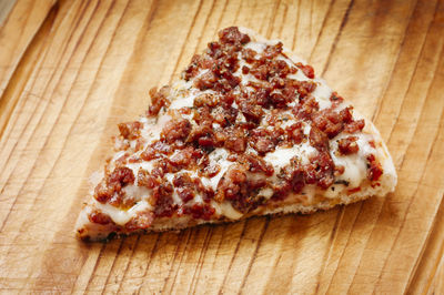 High angle view of pizza on cutting board