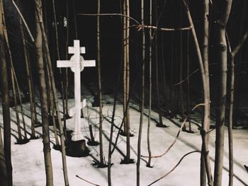 Metal fence on snow covered field by building