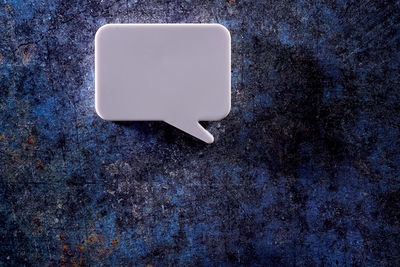 Blank white speech bubble isolated on blue background.