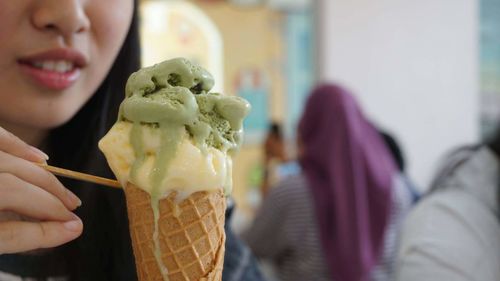 Close-up of woman holding ice cream cone