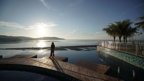 View of swimming pool by sea against sky