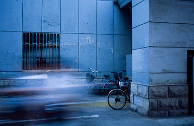 Bicycle parked on street against building