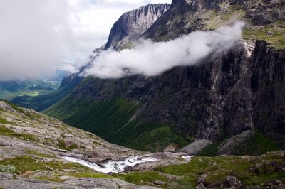 Scenic view of mountains against cloudy sky