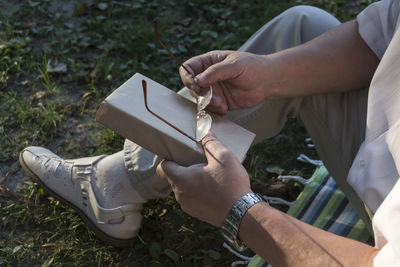 Midsection of man holding book