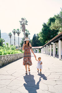 Rear view of women walking on walkway