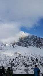 Scenic view of mountains against cloudy sky