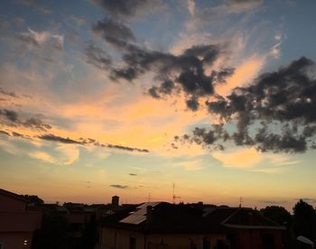 Silhouette city against sky during sunset