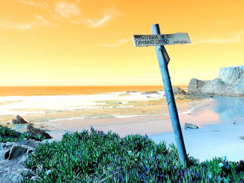 Scenic view of beach against sky during sunset