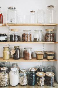 Mason jars arranged on shelves in convenience store