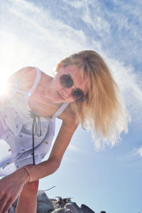 Portrait of woman wearing sunglasses against sky