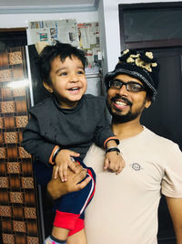 Portrait of happy friends standing against wall