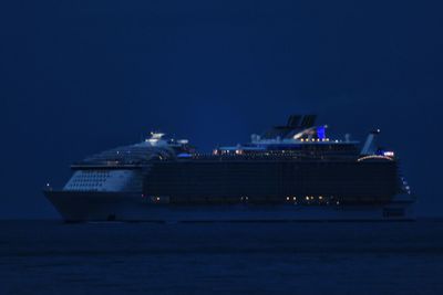 Airplane on sea against sky at night