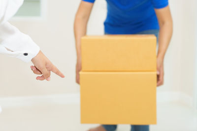 Close-up of man holding woman standing at home