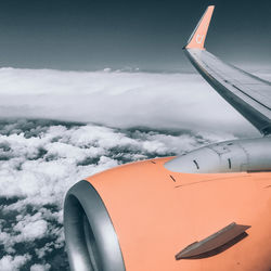 Airplane flying over cloudscape against sky