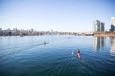 High angle view of people in canoe on river against sky