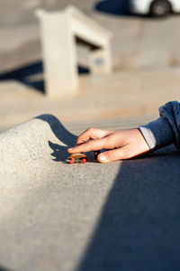 Riding a mini skateboard or fingerboard on outdoors ramp