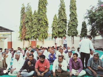 Group of people sitting in front of building