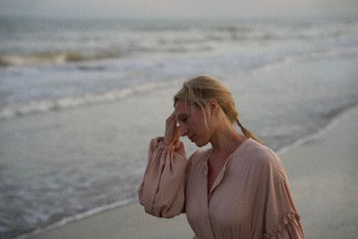Side view of young woman looking at beach