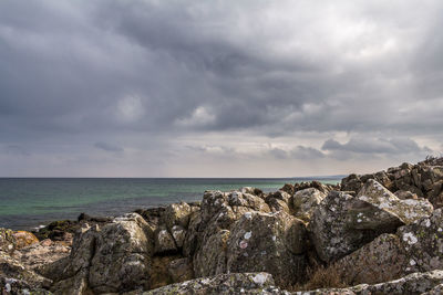 Scenic view of sea against cloudy sky