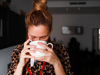 Midsection of woman holding coffee