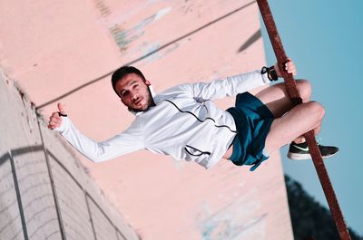 Low angle view of man on wall