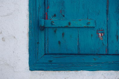 Close-up of blue window on white wall