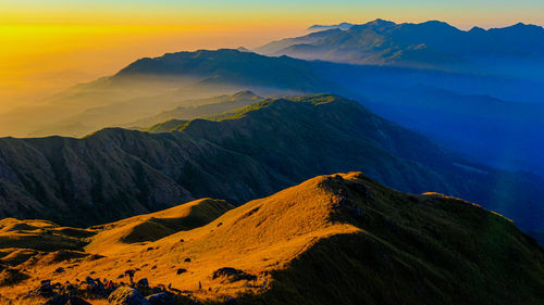 Scenic view of mountains against sky during sunset