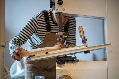 Midsection of man working at workshop