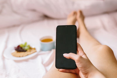 Midsection of man using mobile phone